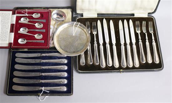 A cased set of six pairs of silver-handled fruit eaters, a similar set of six butter knives and sundries,